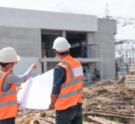 Construction engineers discussion with architects at construction site